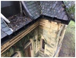 Before: detail of deteriorated mansard dormer showing locations of triangular jamb trim in poor condition
